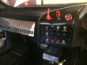 Carbon fibre custom made switch panel, set into custom flocked dash.